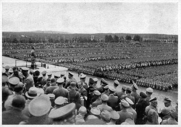Adolf Hitler at the Zeppelinfeld tribune gives his speech to the call of the Politischen Leiter in Nuremberg before 100.000 participants